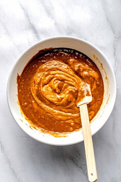 Combining wet and dry ingredients for sweet potato bread.