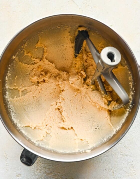 butter and sugars creamed together in a metal stand mixer bowl with paddle attachment