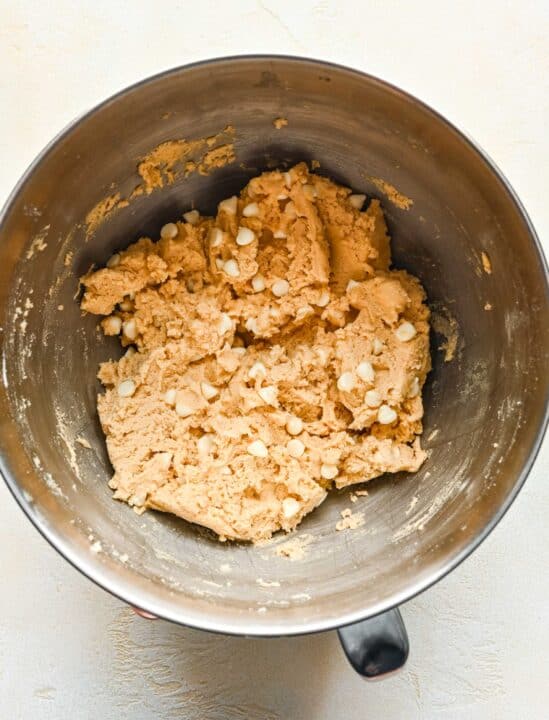 white chocolate chips combined in a metal stand mixer bowl