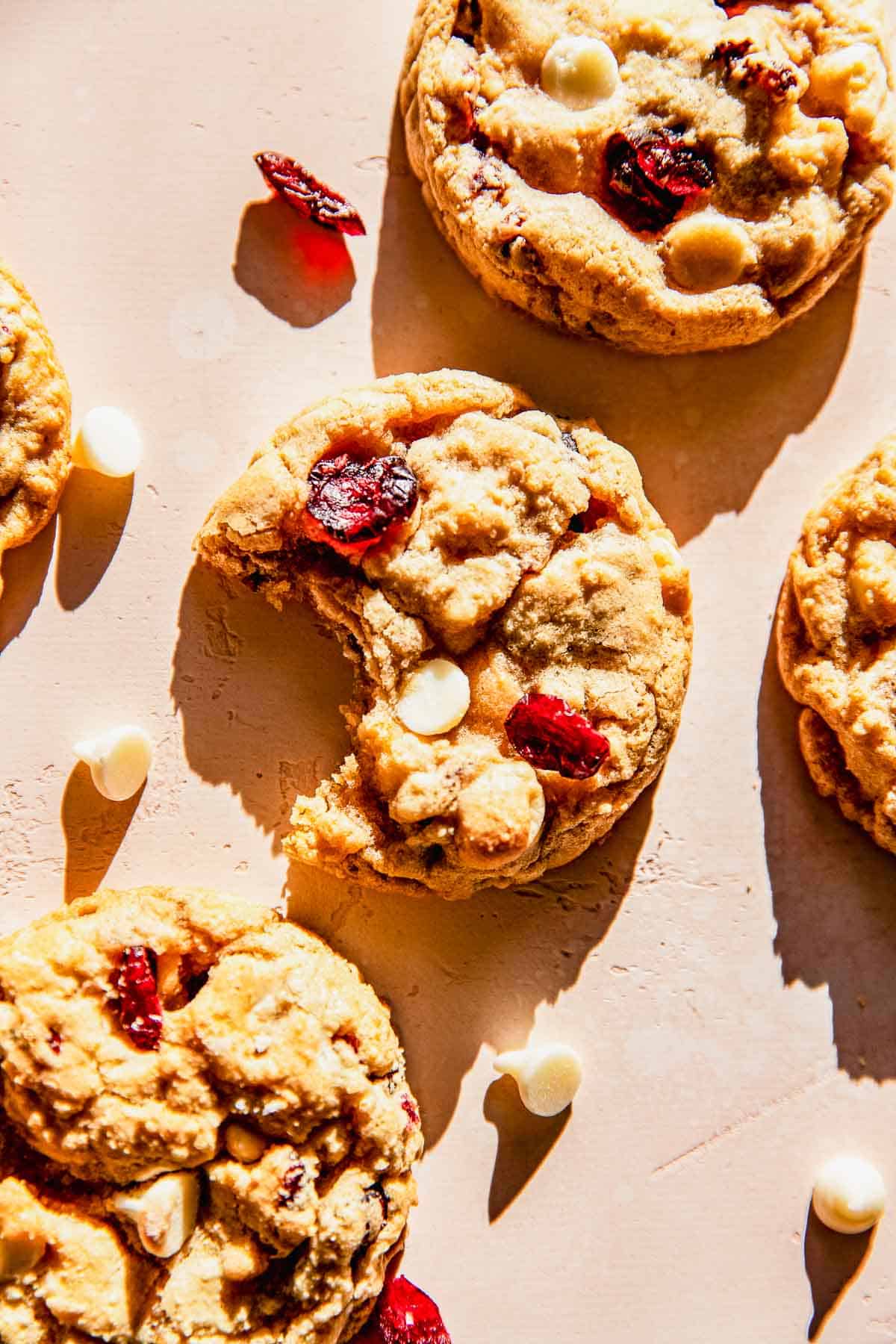 a bitten white chocolate and cranberry cookie in the sunlight