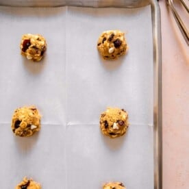 white chocolate and cranberry cookie dough on parchment paper