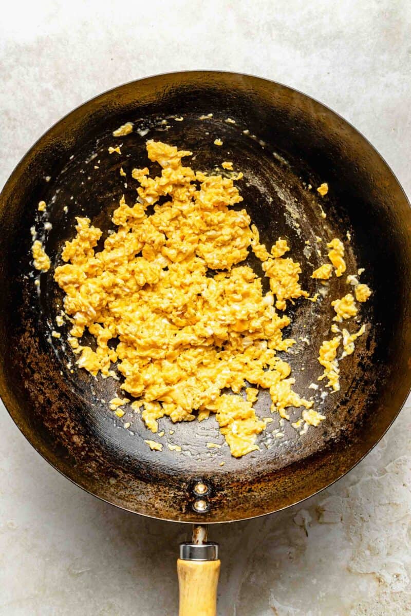 Cooking eggs in a wok.