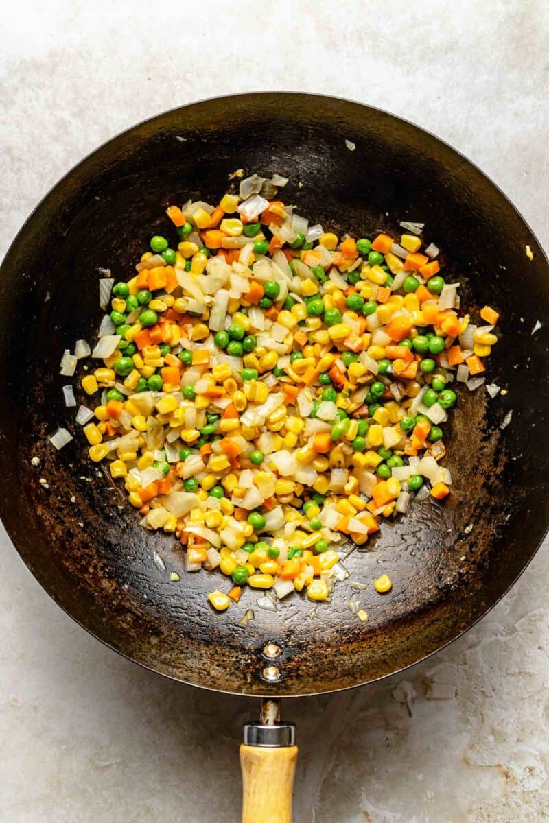 Sauteing vegetables in a wok.