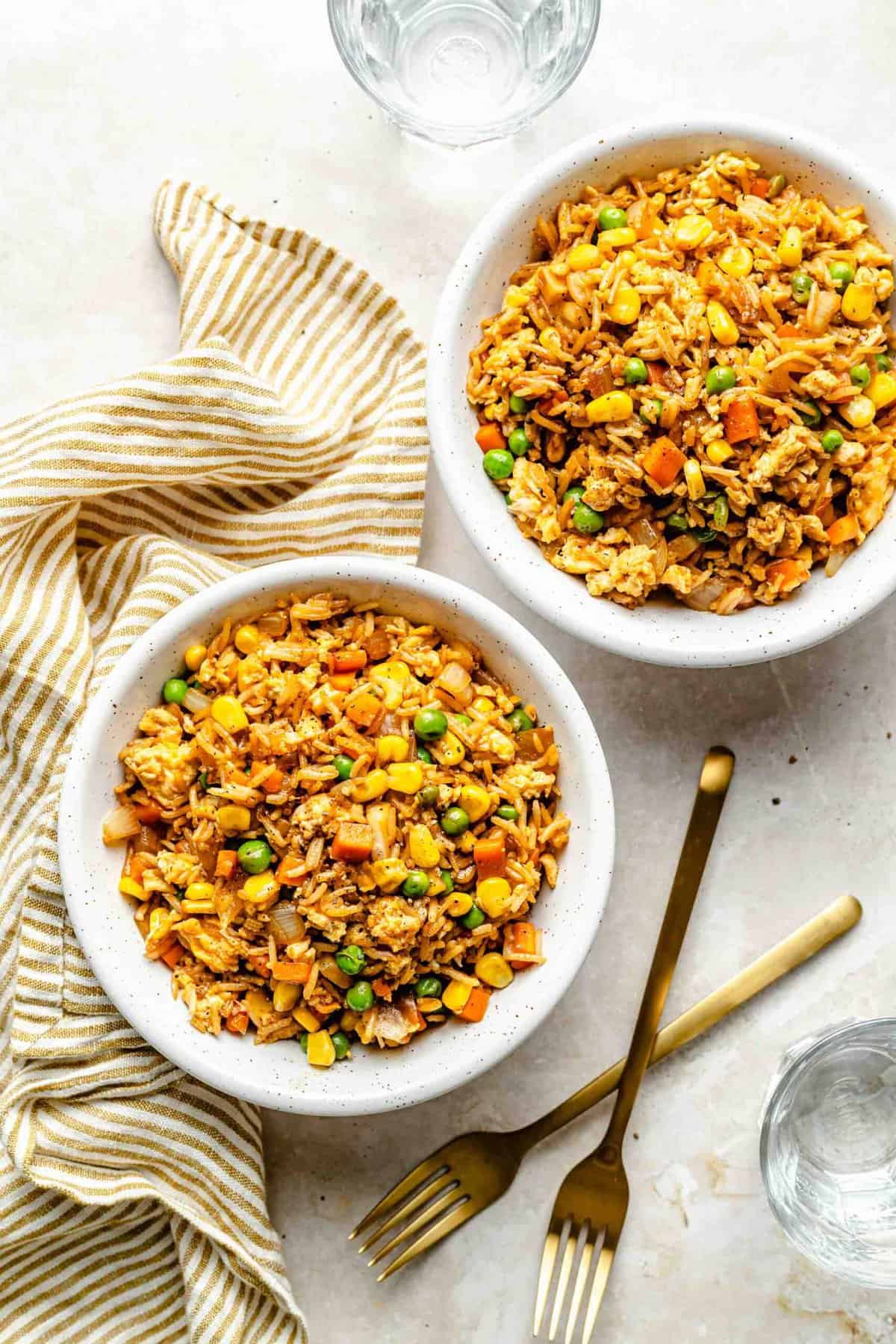 Overhead image of vegetable fried rice in bowls.