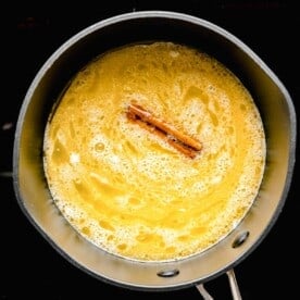 melted butter and a cinnamon stick in a saucepot