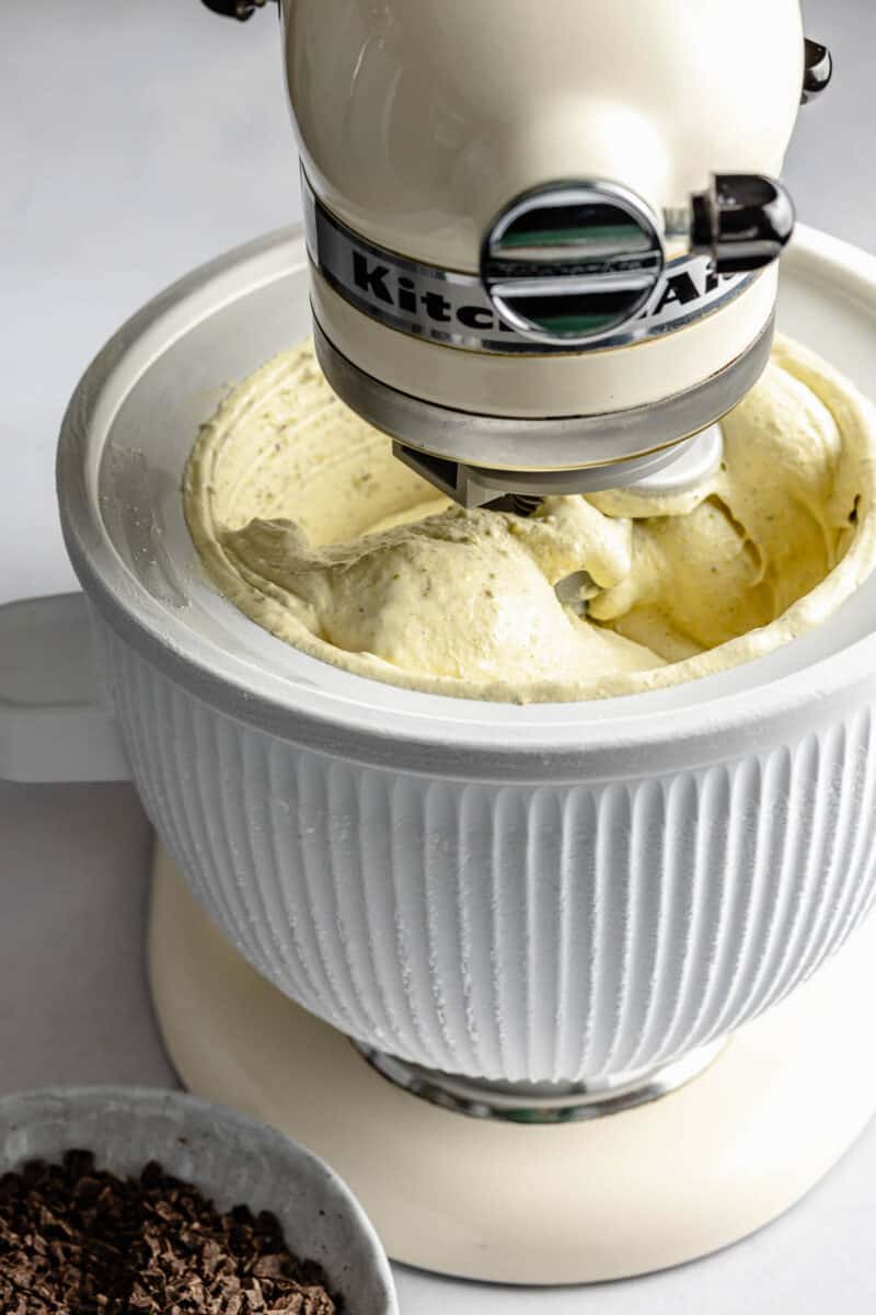 Churning pistachio ice cream in an ice cream maker.