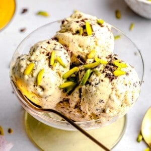 Pistachio ice cream served in a bowl with a spoon.