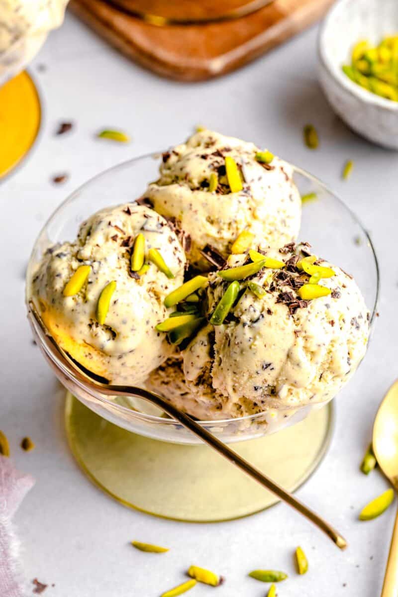 Pistachio ice cream served in a bowl with a spoon.