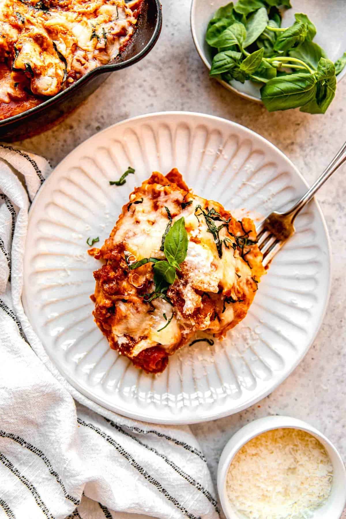 Overhead image of a serving of skillet lasagna on a plate.