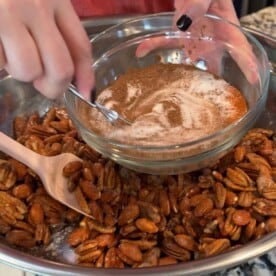 whisking together cinnamon sugar spice mixture in a clear bowl