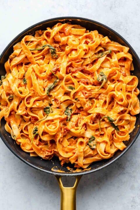 sun-dried tomato pasta in a large black skillet