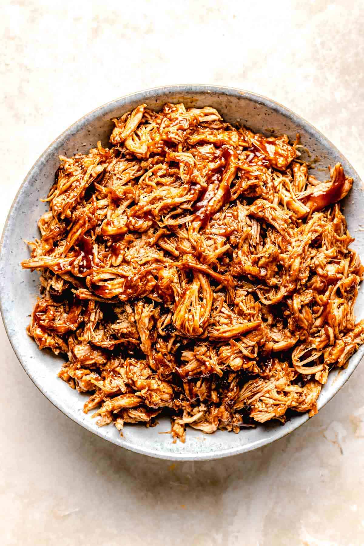 Mixing shredded pork with BBQ sauce,