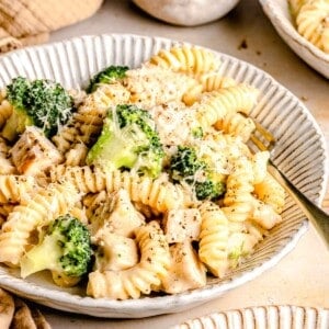 Chicken broccoli Alfredo pasta in a bowl with a fork.
