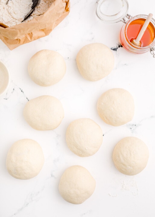 8 dough balls on a marble surface