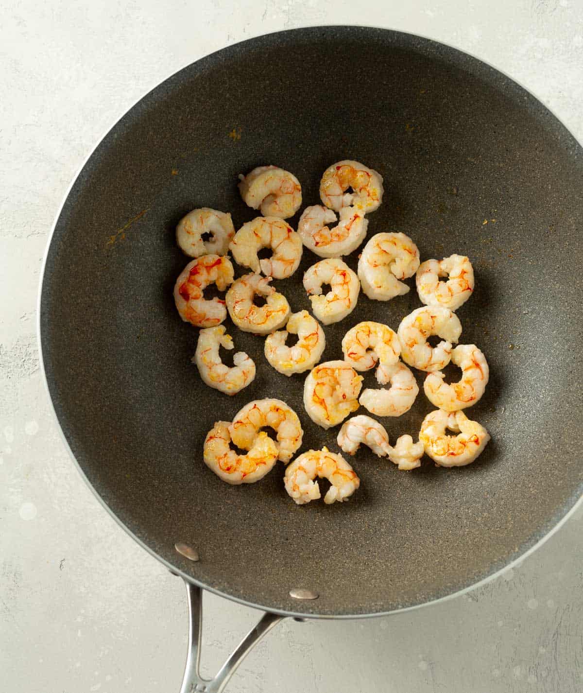 shrimp being cooked in a grey wok