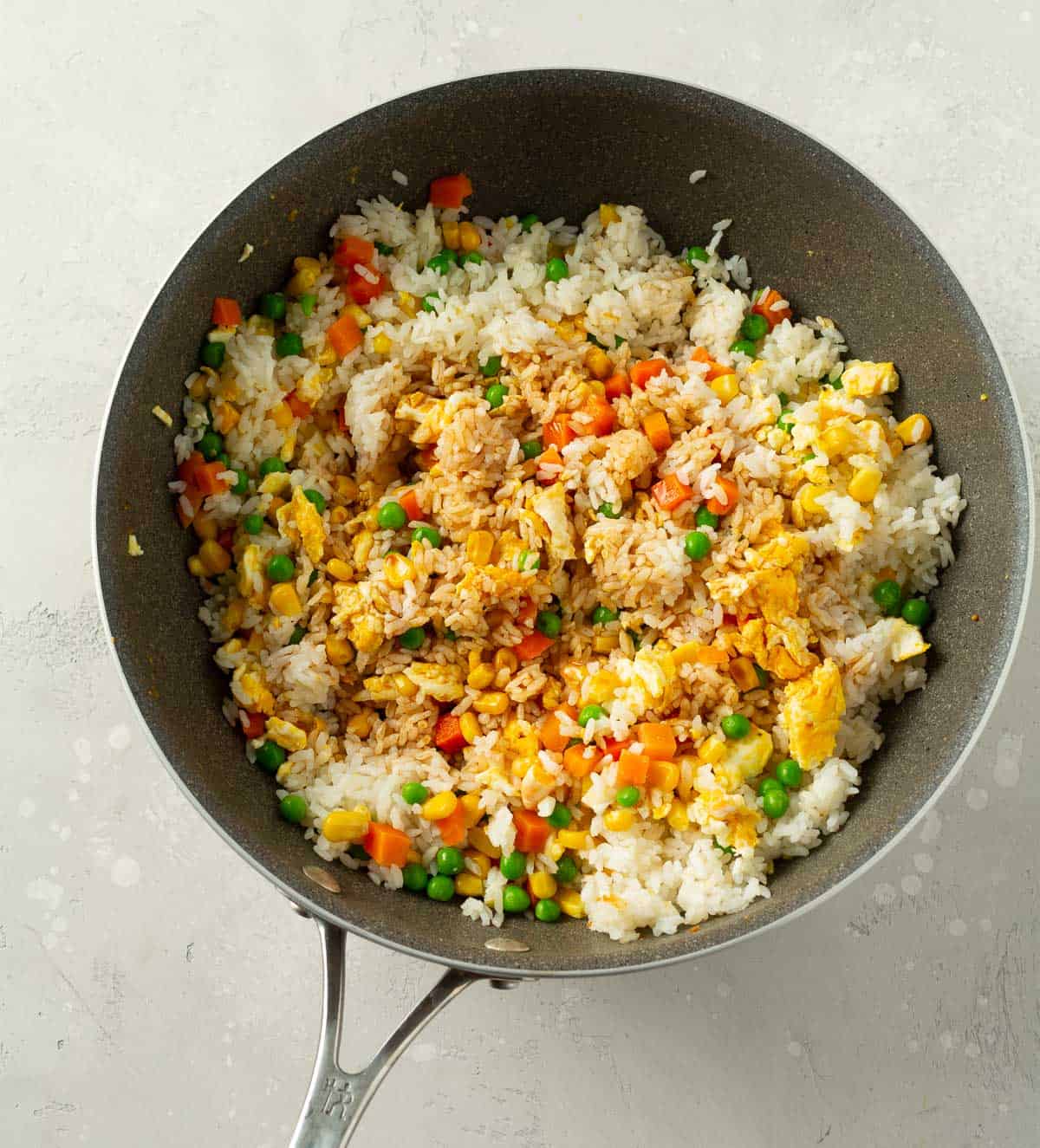 soy sauce added to rice mixture in wok