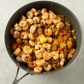 shrimp and butter added to rice mixture in wok