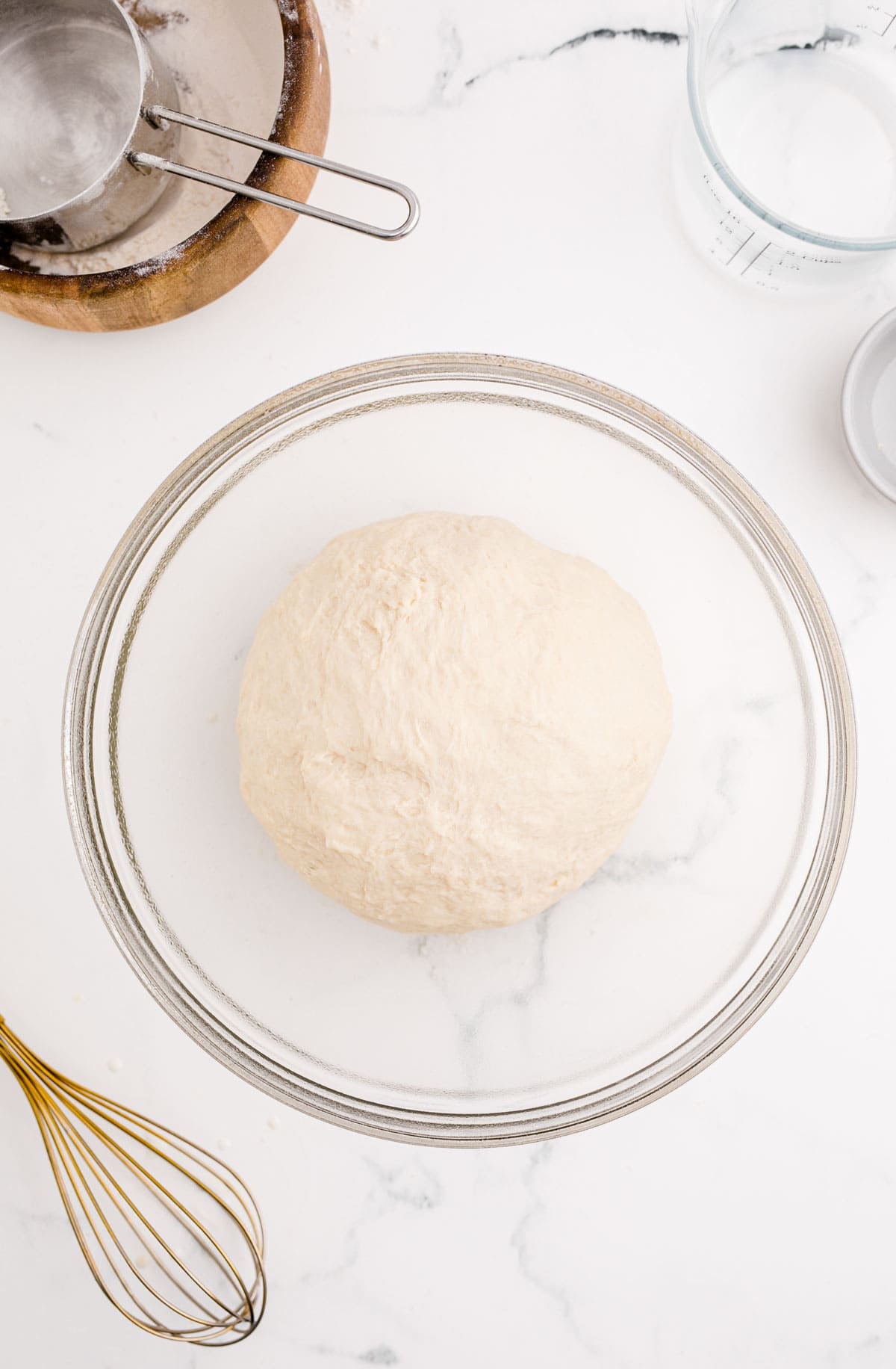 formed dough in a greased clear bowl