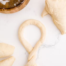 a piece of dough twisted to form a shape of a pretzel