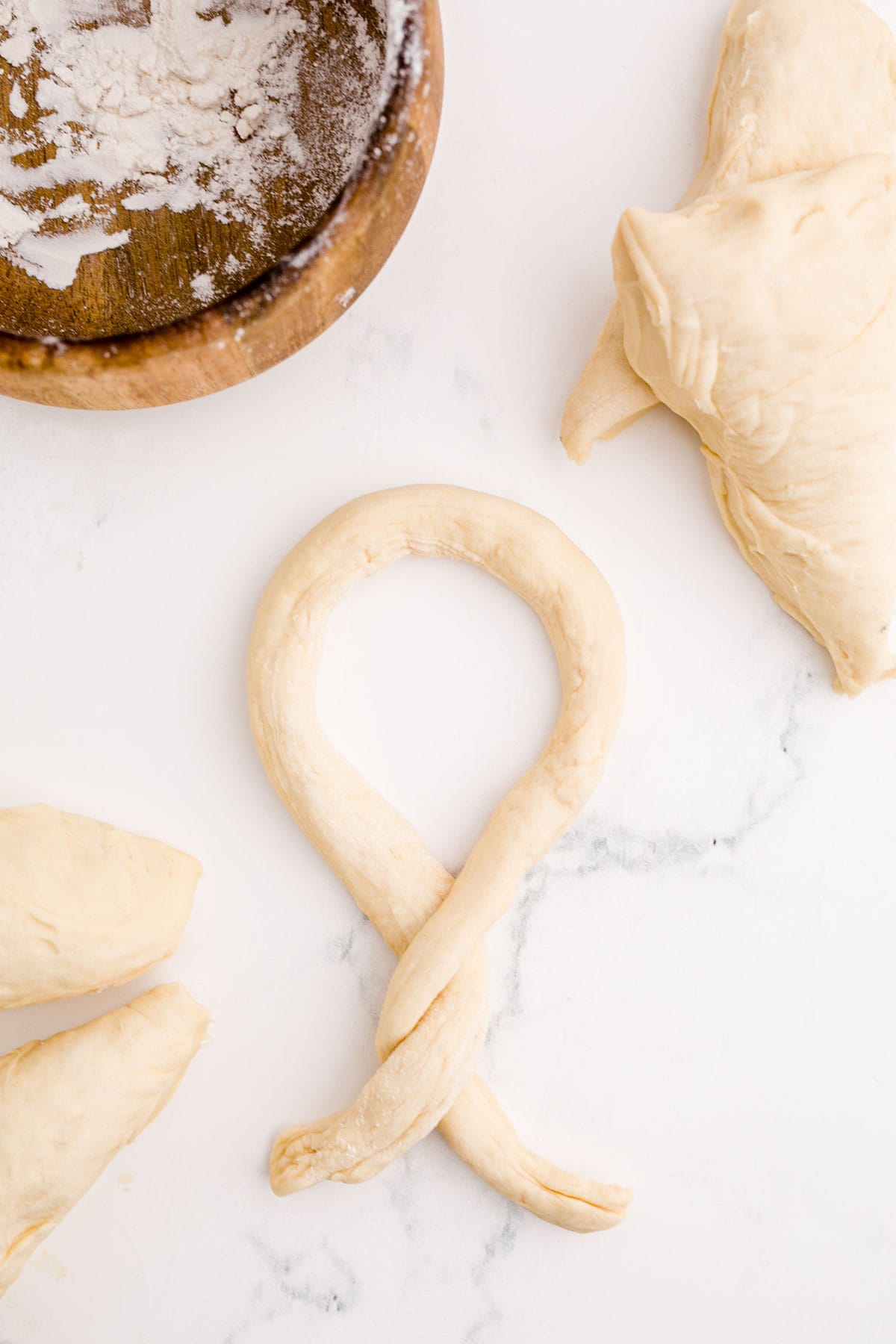 a piece of dough twisted to form a shape of a pretzel