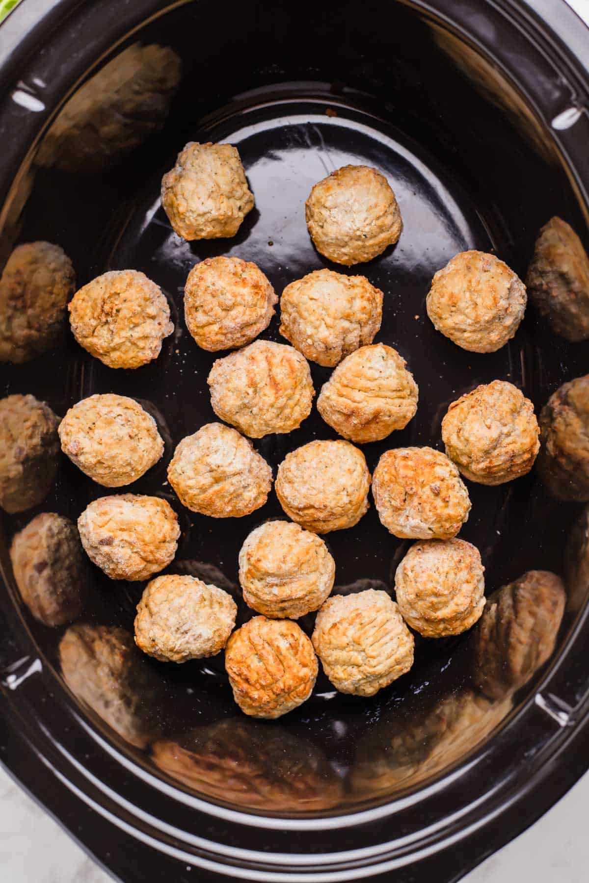 frozen meatballs in the insert of a slow cooker