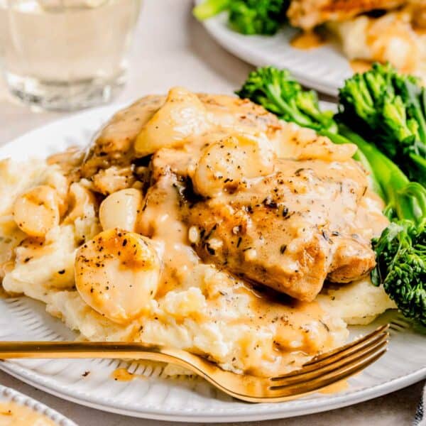 40 clove garlic chicken on a plate with broccolini.