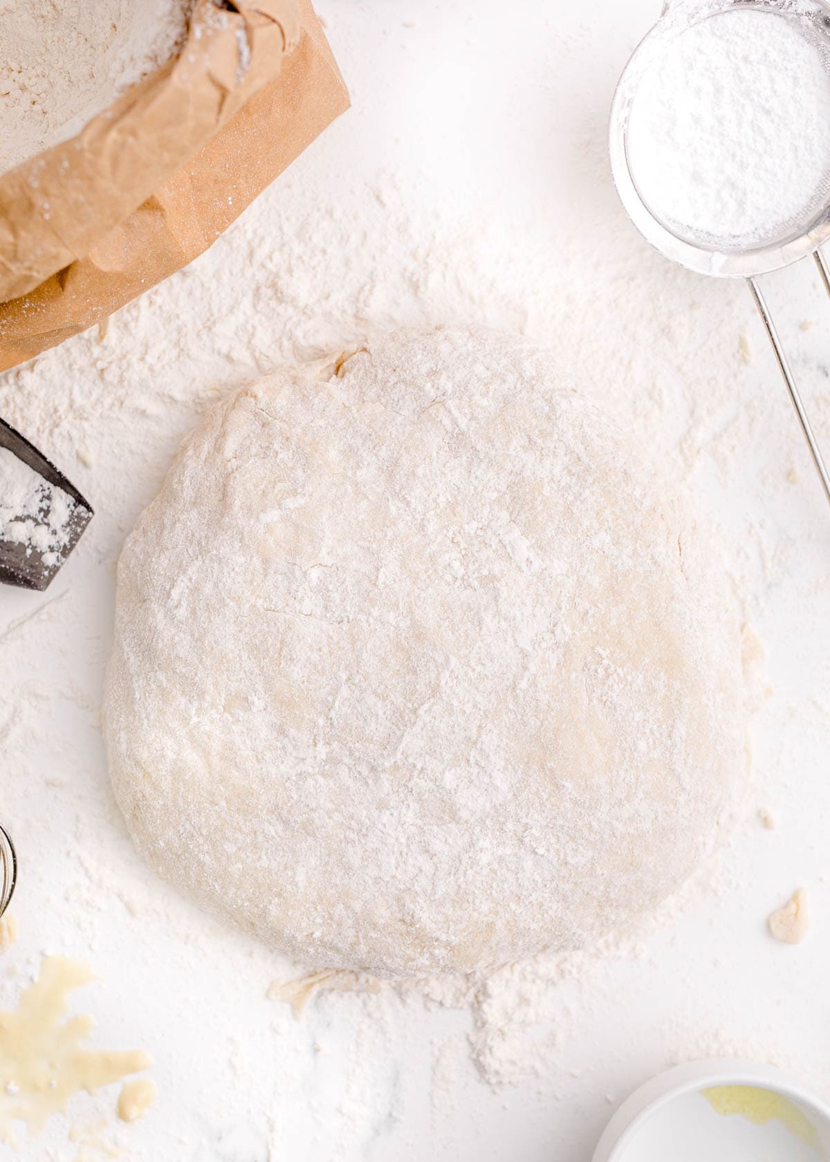 dough rolled out into a large circle on a floured work surface