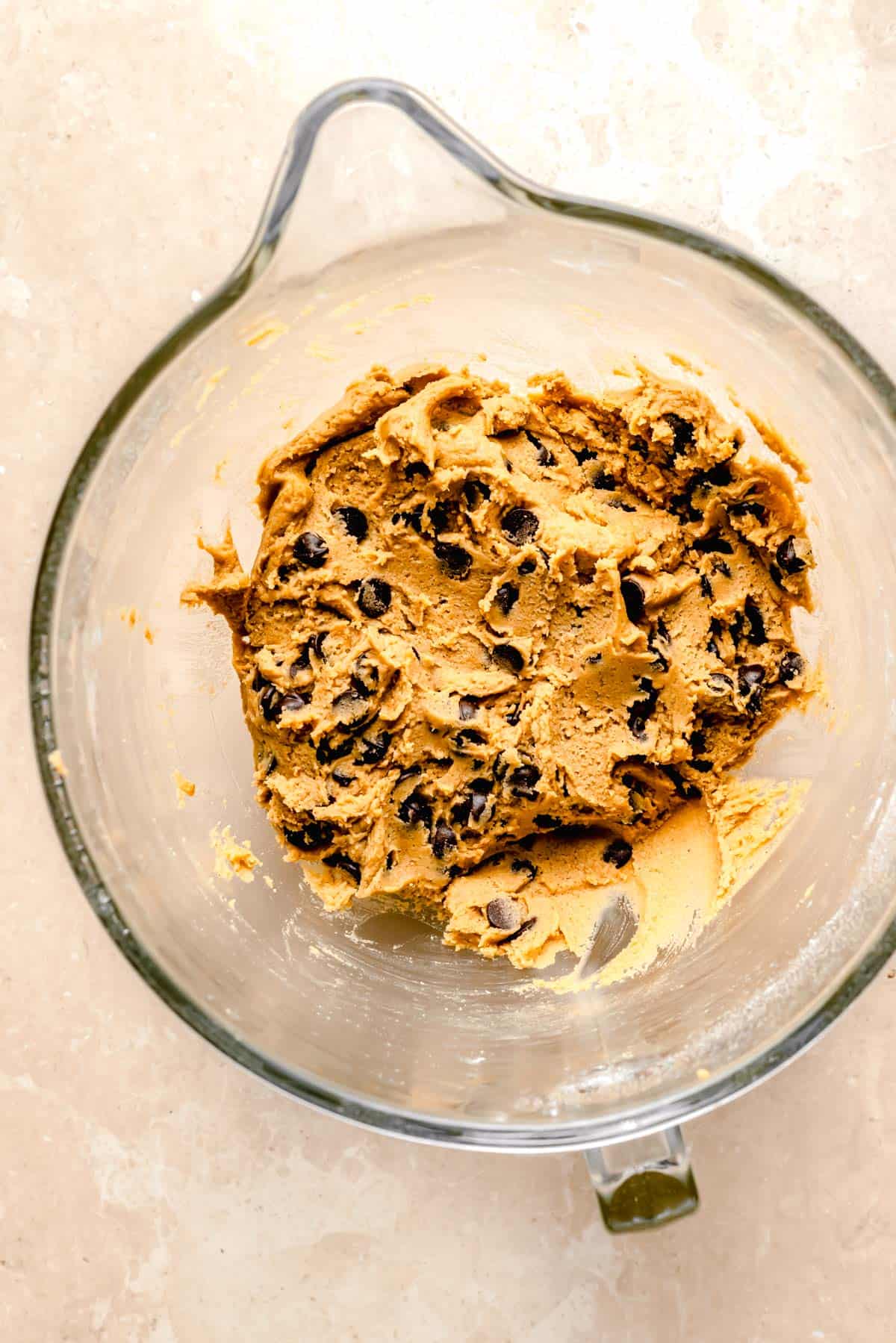 cookie dough is in a glass mixing bowl