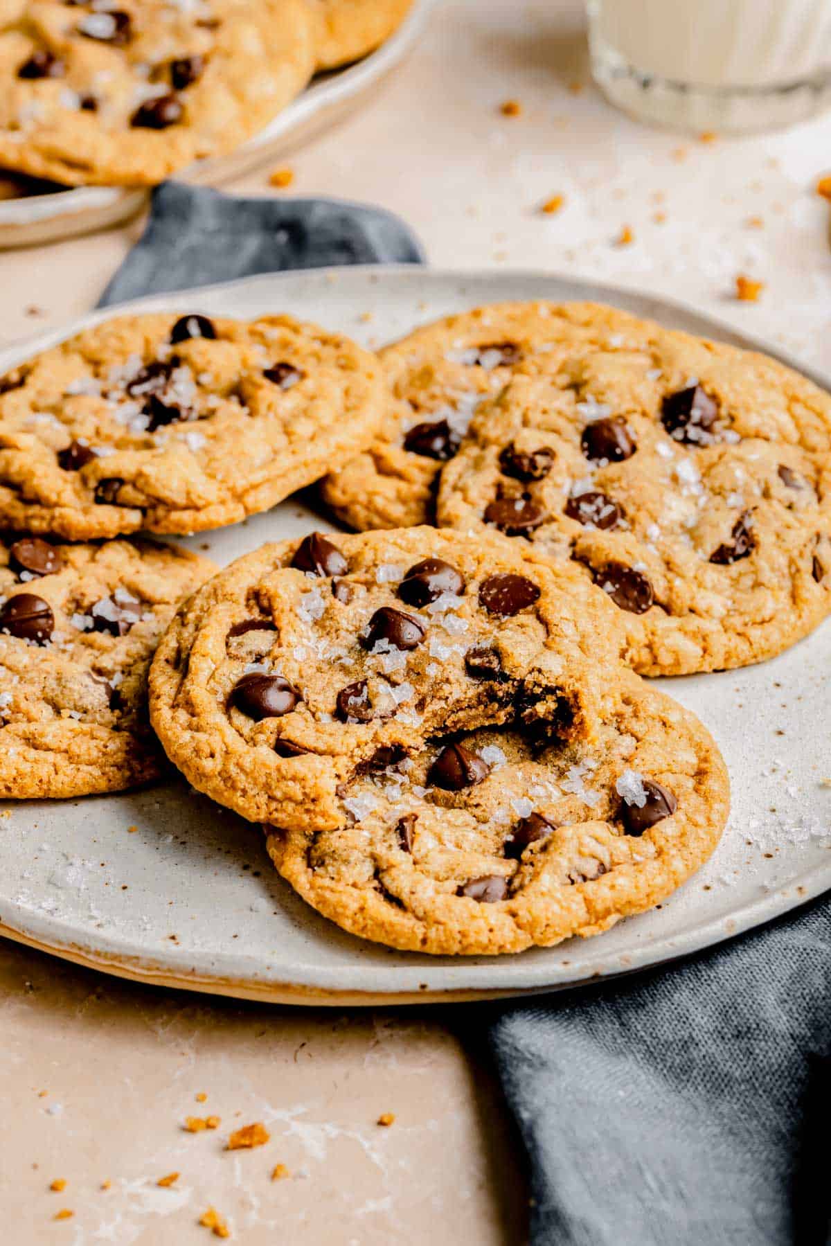 several chocolate chip cookies are on a round plate