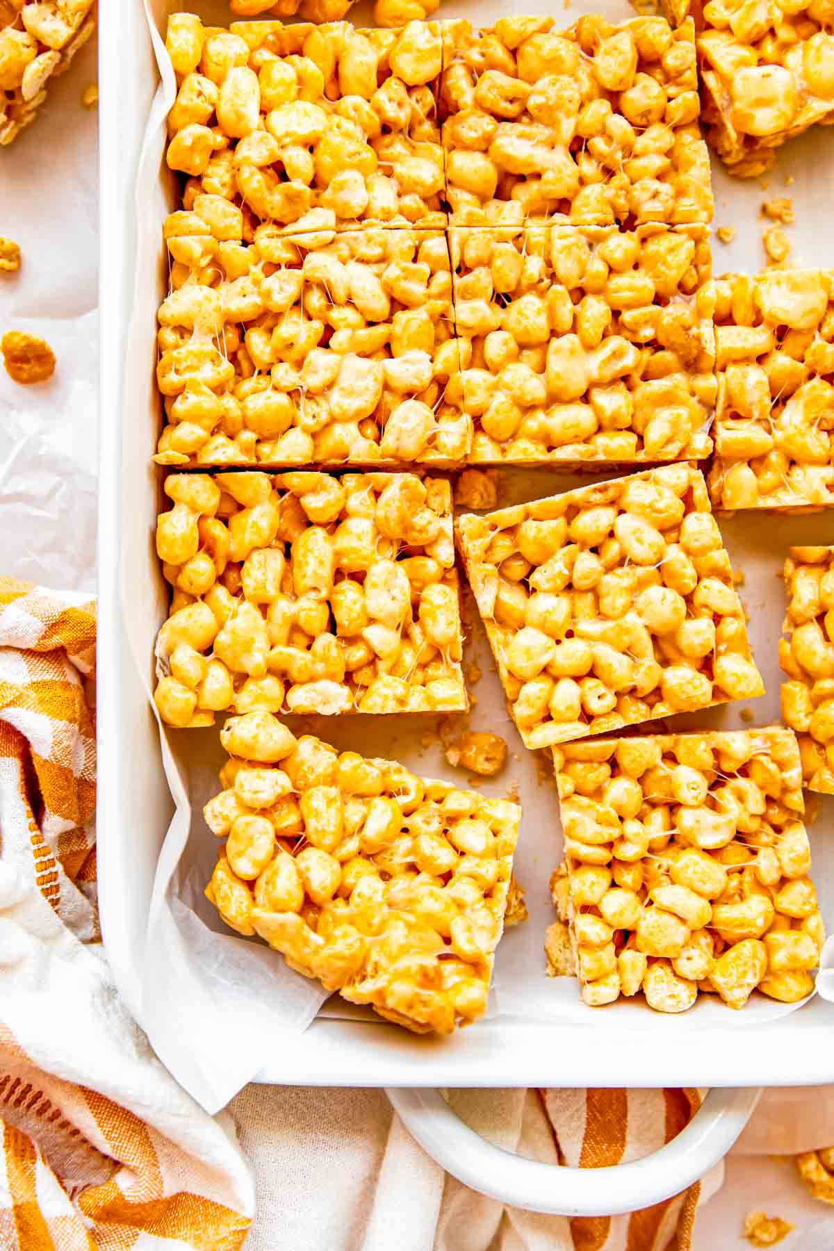 Several cereal bars are placed in a white baking dish. 