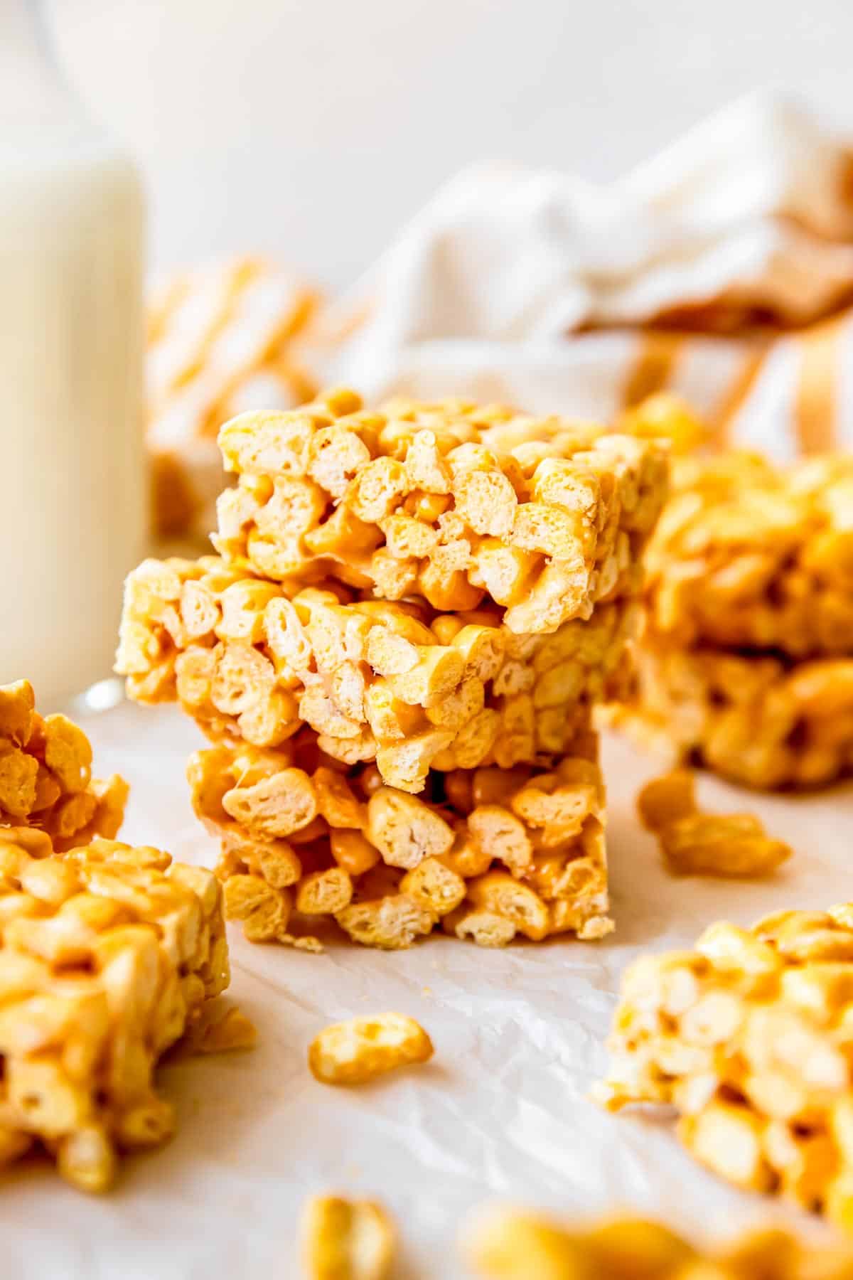 A stack of cereal bars are placed on a countertop. 