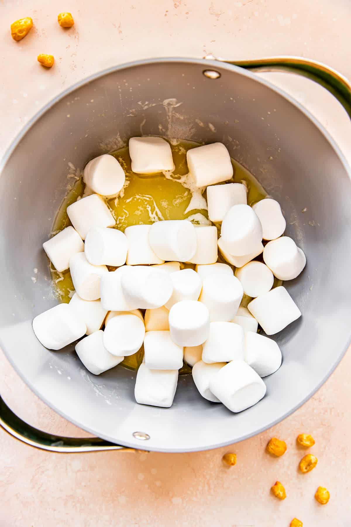 Marshmallows have been added to a skillet with melted butter. 