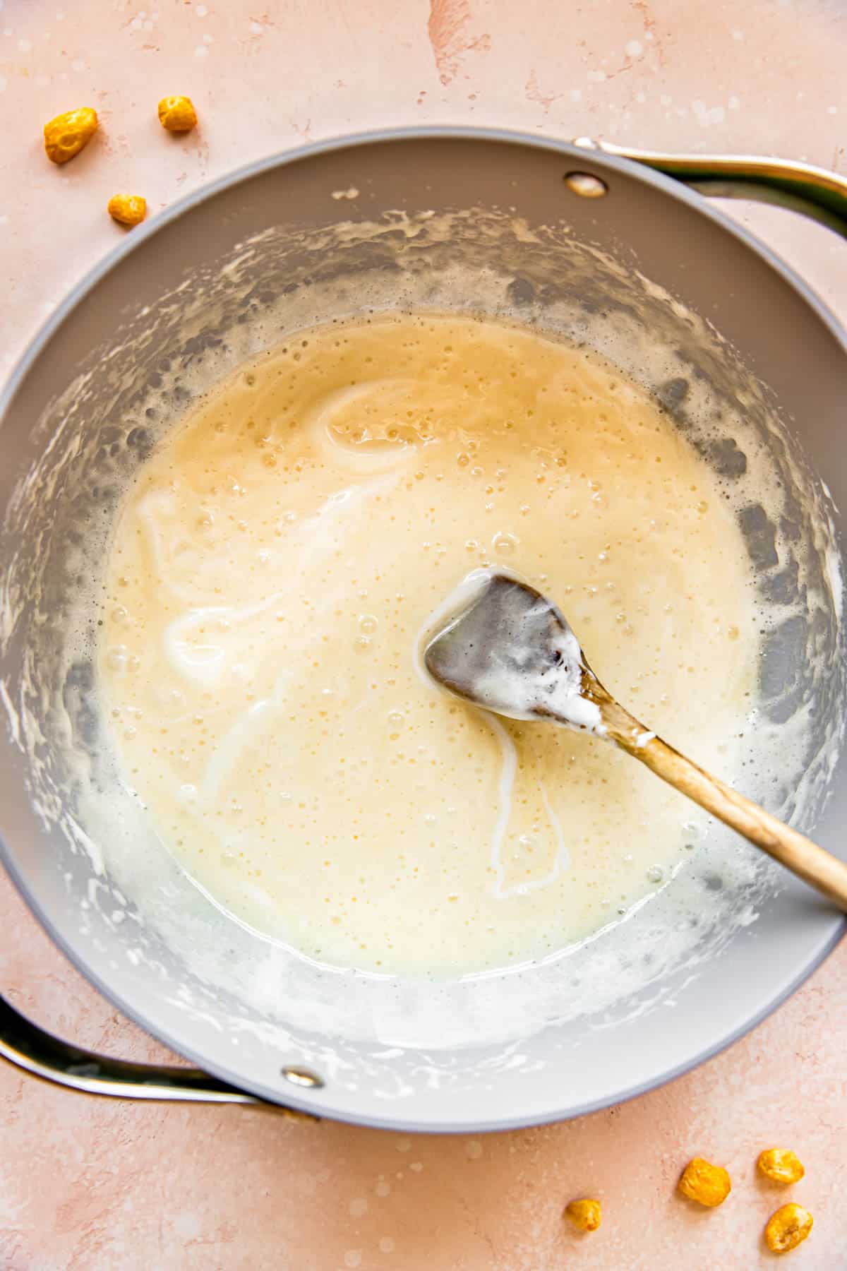 Marshmallows have melted into butter in a pan.