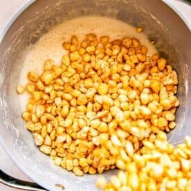 Corn Pops cereal is being added to a pan.
