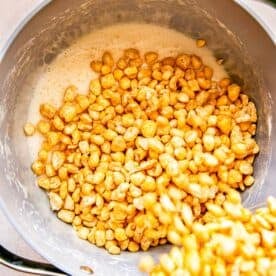 Corn Pops cereal is being added to a pan.