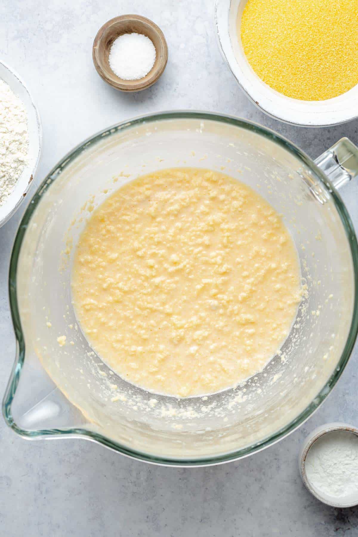 Wet ingredients for cornbread batter in a mixing bowl.