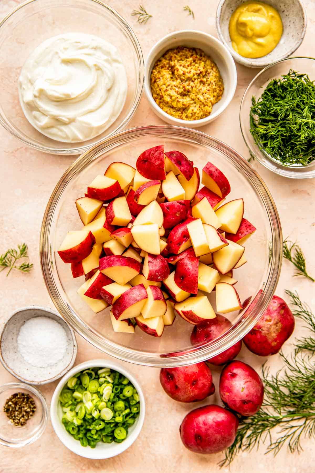 The ingredients for dill potato salad are placed on a countertop. 