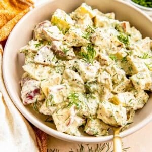 A bowl is filled with creamy potato salad.