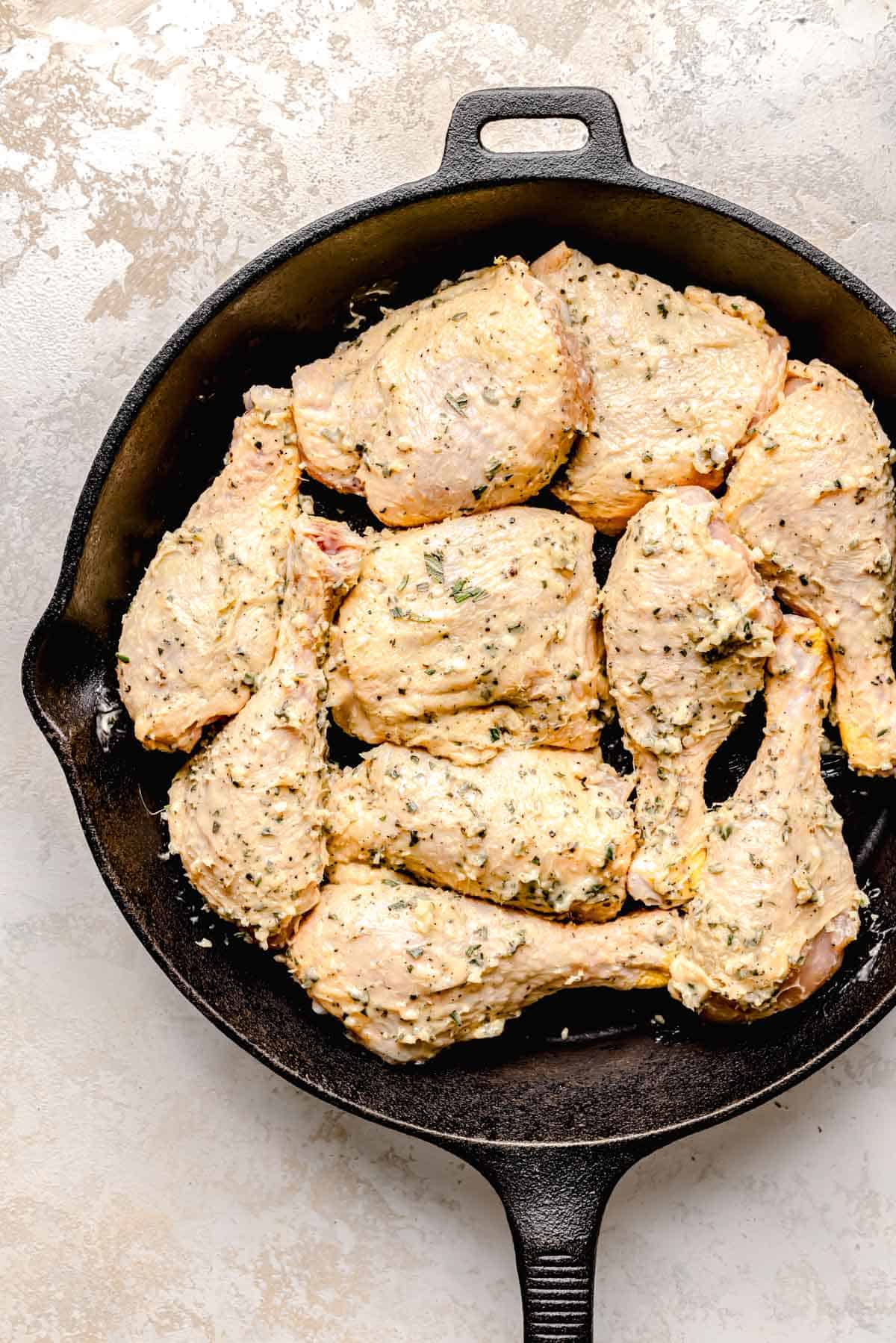 uncooked chicken pieces are coated in butter