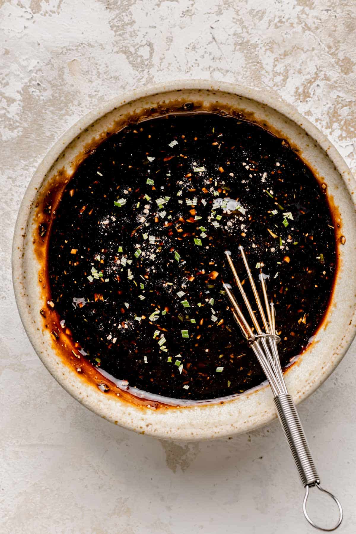 the fig glaze is being whisked together in a bowl