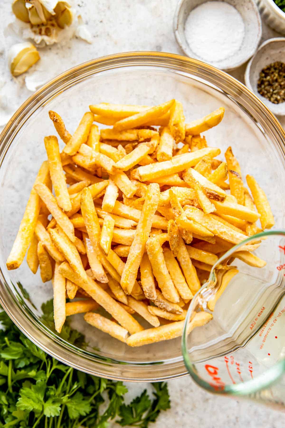 Fries are presented in a glass bowl. 