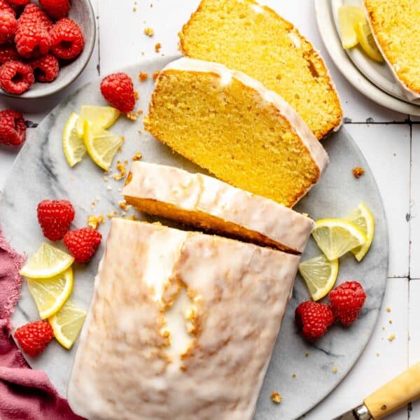 Several slices of pound cake are placed beside the cake.