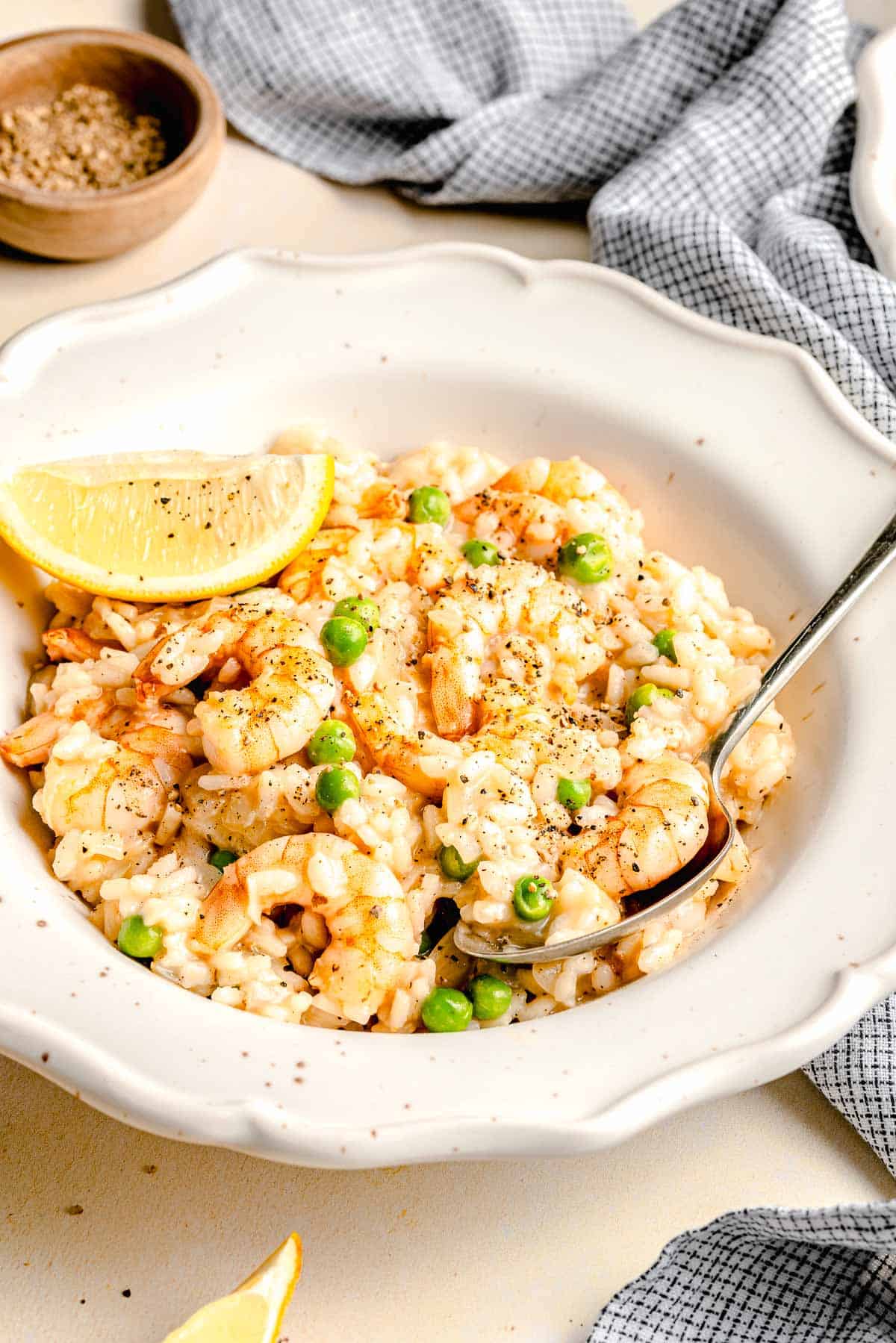 Shrimp risotto in a bowl with a spoon.