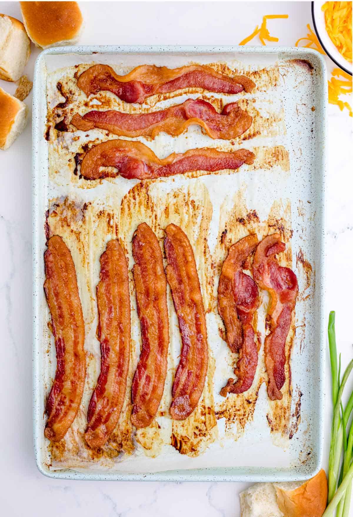 cooked bacon on a metal baking sheet