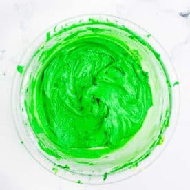 Dark green icing is in a bowl.