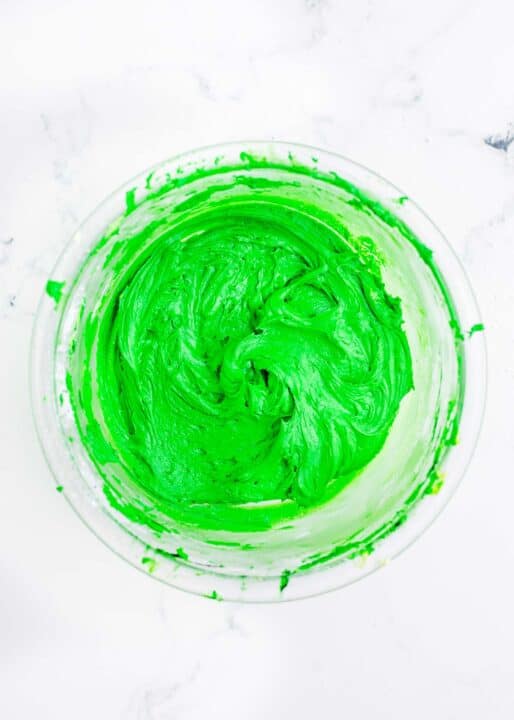 Dark green icing is in a bowl.