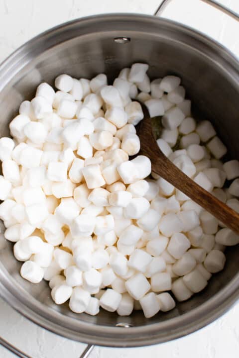 mini marshmallows have been added to a pot of melted butter
