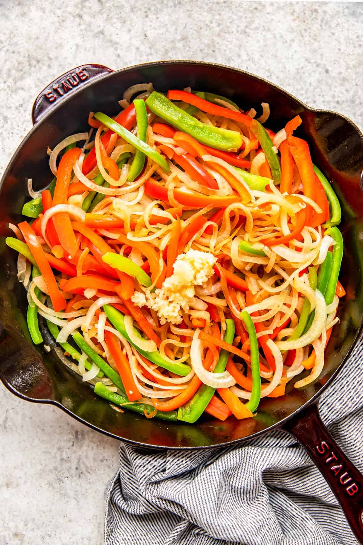 bell peppers, onions, and garlic in a cast iron skillet