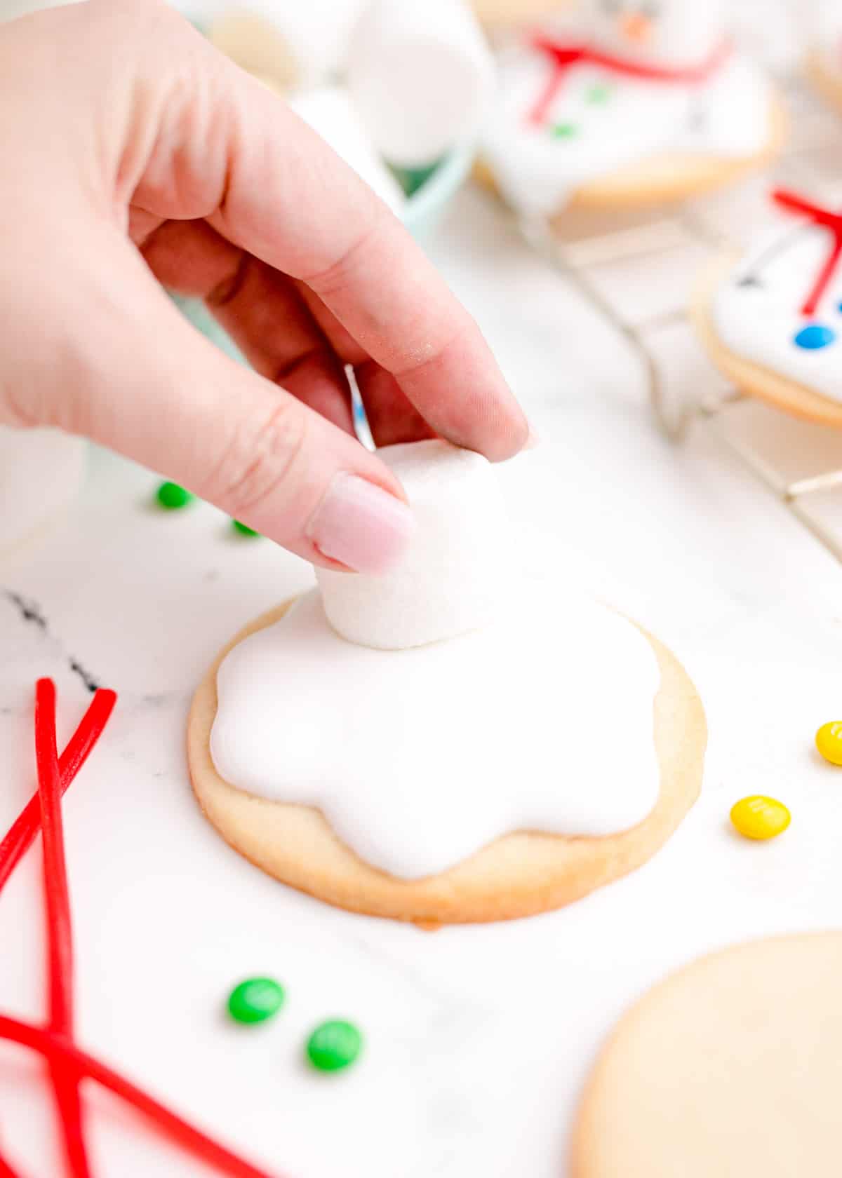 a marshmallow is being placed on top of the icing