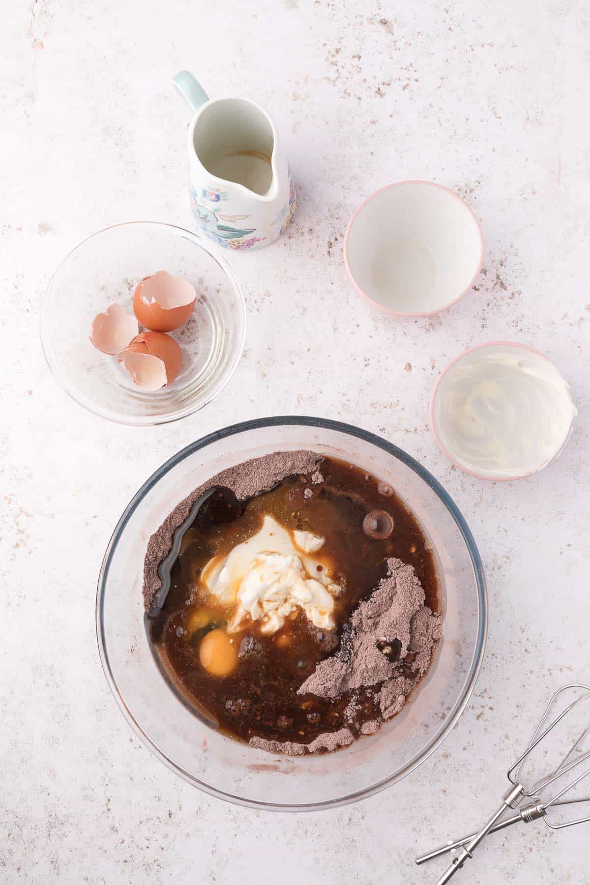 dry and wet ingredients for mini bundt cakes in a glass bowl